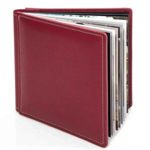Red photo album with multiple pages, on a white background.